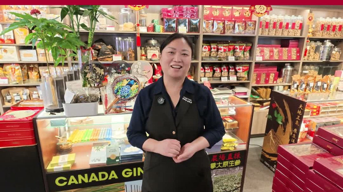 Lucy, a Fosetter employee, smiling behind the counter of the ginseng shop in Montreal's Chinatown.