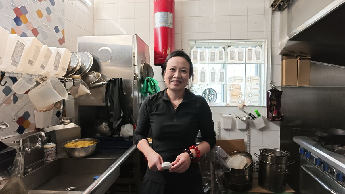 Carmen smiling in a restaurant kitchen during our shoot.
