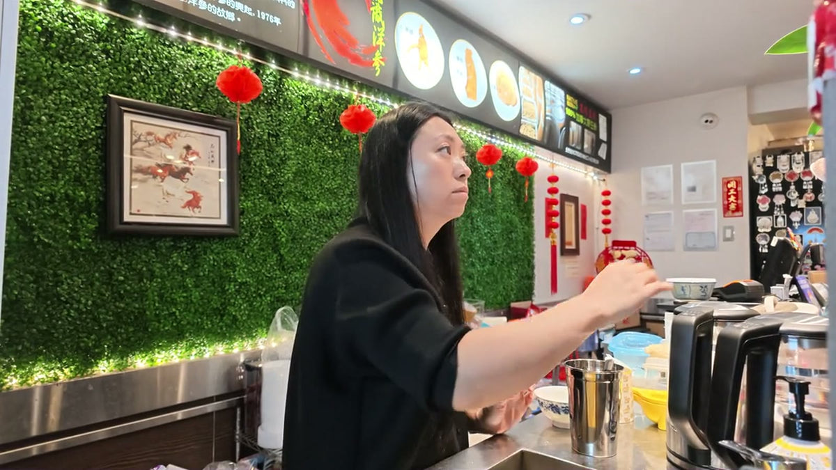 A Fosetter team member preparing drinks at the tea bar inside the shop.