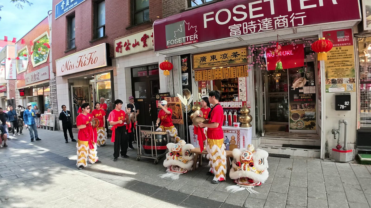 The lion dance team sets up in front of the Fosetter storefront in Montreal's Chinatown.